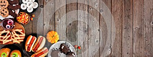 Halloween party food corner border over a rustic wood background with copy space