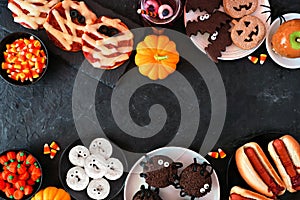 Halloween party food double border over a black stone background