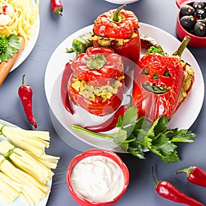 Halloween party food. Red stuffed peppers with scary cutout faces, witches brooms of cheese and other treats