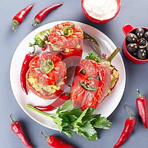 Halloween party food. Red stuffed peppers with scary cutout faces, witches brooms of cheese and other treats