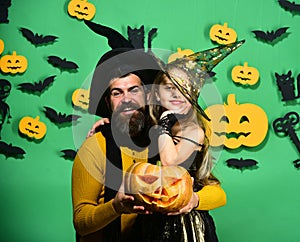 Halloween party and holiday concept. Father and daughter in costumes