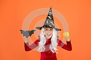 Halloween party. Small girl in black witch hat. Autumn holiday. Join celebration. Halloween attributes. Little child in