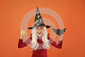 Halloween party. Small girl in black witch hat. Autumn holiday. Join celebration. Halloween attributes. Little child in