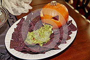 Halloween Party Spread with Jack-o-Lantern, Blue Chips and Homemade Guacamole
