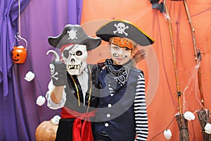 Two little boys in different pirate costumes with faceart are ha photo