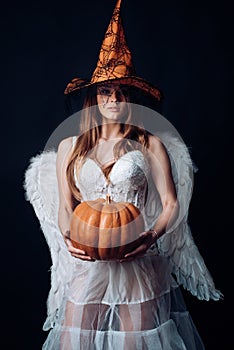 Halloween people in angel costume. Happy Halloween Angelic Witch. Halloween Party girl. Beauty Halloween angel girl with