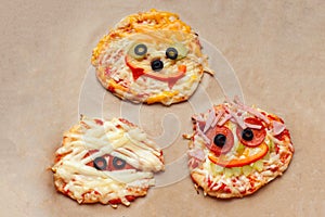 Halloween pizza with monsters, above scene with decor on a craft paper box background, idea for home party food, easy, healthy