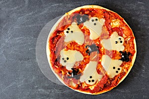 Halloween pizza overhead view on slate