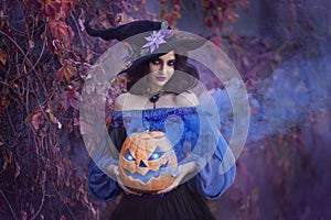 Halloween portrait fantasy woman witch. Girl sorceress in vintage purple costume medieval dress, tall cone hat. Magician