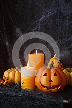 Halloween pumpkin with candle and spiders