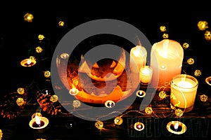 Halloween pumpkin in the darkness. Lights lamps and candles. Mystical autumn holiday. Festive details. Trick-or-treat tradition.