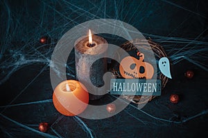 Halloween pumpkin decor with candle and spiders