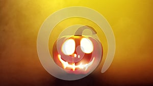 Halloween Pumpkin enlighted with candle lantern in yellow smoky atmosphere