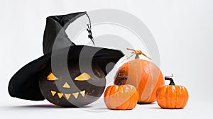 Halloween. Pumpkin with glowing eyes and a terrible smile. There is a blinking fire inside the pumpkin. A witch's hat is