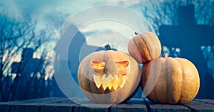 Halloween pumpkin glowing on gothic graveyard