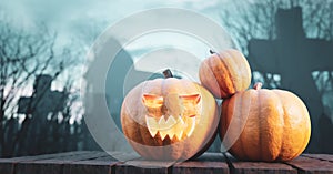 Halloween pumpkin glowing on gothic graveyard