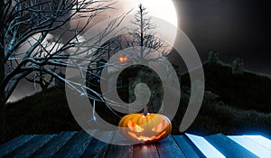 Halloween pumpkin in graveyard with full moon night
