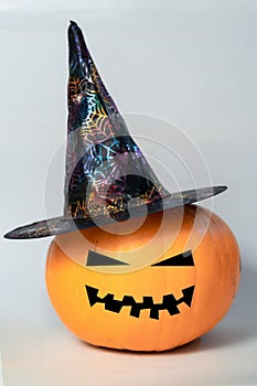 Halloween pumpkin with hat on a white background