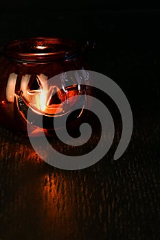 Halloween pumpkin head bowl lantern on dark background