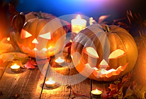 Beauty model girl in colorful bright lights with trendy makeupHalloween pumpkin head jack lantern with burning candles