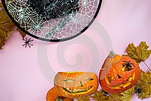 Halloween pumpkin head jack lantern frame with burning candles, witch hat and spider isolated on orange, flat lay with