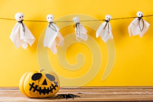 Halloween pumpkin head jack lantern smile and spider on wooden