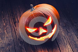 Halloween pumpkin head jack lantern on wooden background