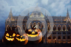 Halloween pumpkin head jack lanterns in front of ancient spooky castle