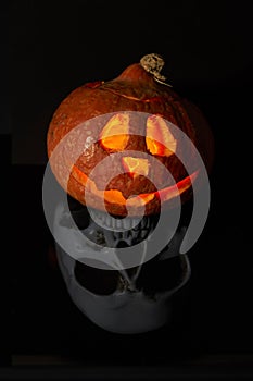 Halloween pumpkin head lantern on black background. Jack-o-lantern carved pumpkins for Halloween close up. Halloween pumpkin with
