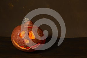 Halloween pumpkin head lantern on wooden background . Jack-o-lantern carved pumpkins for Halloween close up. Halloween pumpkin