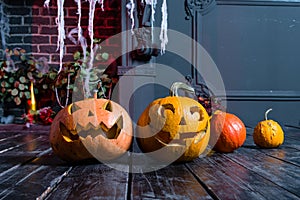 Halloween pumpkin heads jack lantern on dark wooden background,