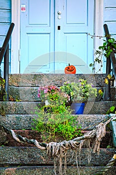 Halloween pumpkin on house porch.