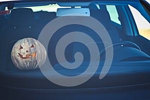 Halloween pumpkin inside a car