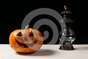 Halloween pumpkin and lamp. Happy Halloween holiday background with old vintage lamp