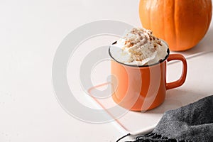 Halloween pumpkin latte coffee with whipped cream decorated spiders