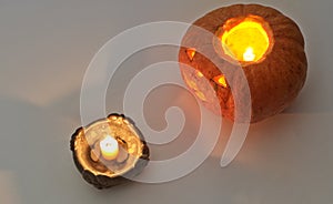 Halloween pumpkin with a lighted candle, at the candleholder