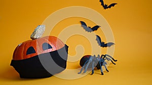 Halloween pumpkin in medical mask,spider and bats on orange background.concept championed Halloween holiday during Covid19