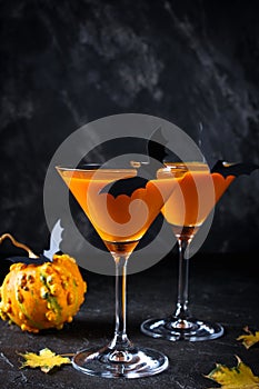 Halloween pumpkin orange cocktails. Festive drink. Halloween party. Funny Pumpkin with holiday  decorations