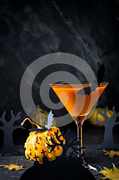 Halloween pumpkin orange cocktails. Festive drink. Halloween party. Pumpkin with holiday decorations