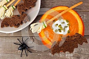 Halloween pumpkin soup with witches broom and bat bread snacks