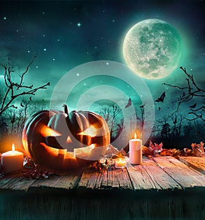 Halloween Pumpkin In A Spooky Forest At Night photo