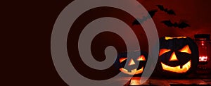 Halloween Pumpkin on wooden table in front of spooky dark background. Jack o lantern