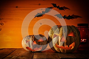 Halloween Pumpkin on wooden table in front of spooky dark background. Jack o lantern