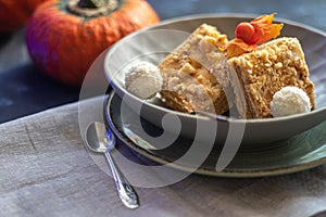 Halloween Pumpkins of bright orange color lie on a dark background, next to red berries.