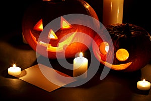 Halloween pumpkins with candles and card