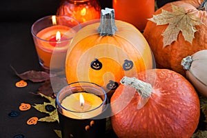 Halloween pumpkins and candles on dark