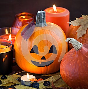 Halloween pumpkins and candles on dark