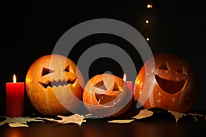 Halloween pumpkins and candles on dark background