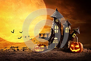 Halloween pumpkins and Castle spooky in night of full moon and bats flying