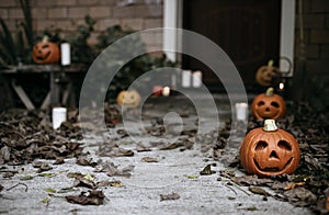 Halloween pumpkins and decorations outside a house